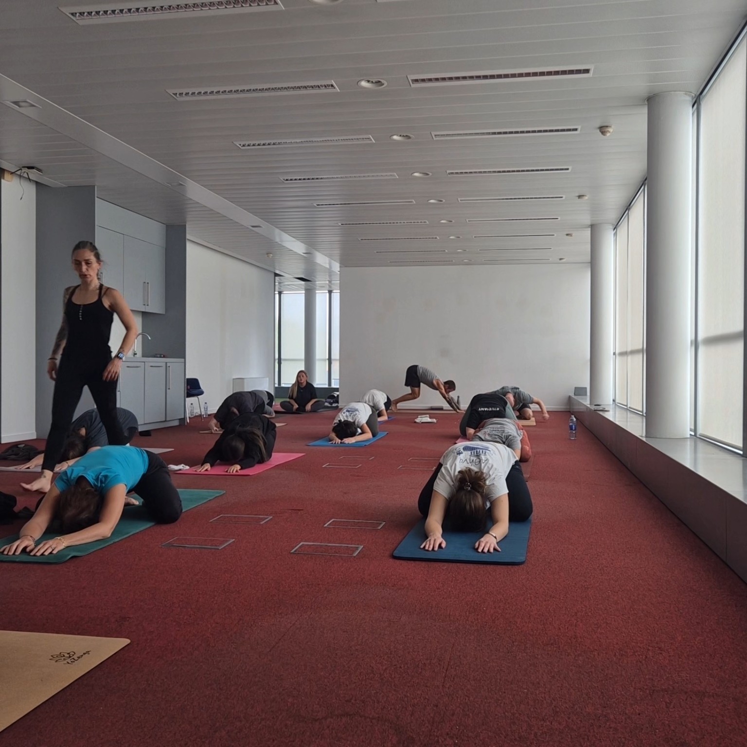 Groupe de collaborateurs en posture de l'enfant, moment de relâchement pendant la séance